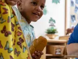A young boy holding a toy at Little Hulton Nursery