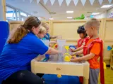 A nursery worker playing with some children