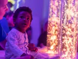 A baby boy sat in the sensory room at Higher Broughton Nursery